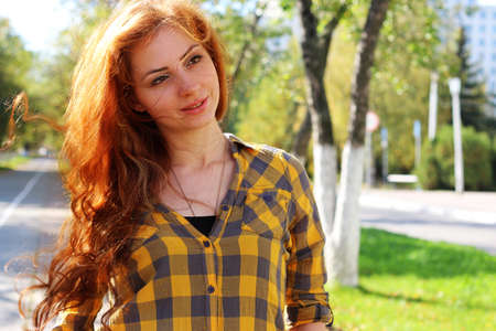 Pretty cute girl walks in the park on a sunny dayの写真素材