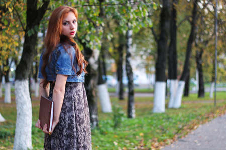 Pretty cute girl walks in the park on a sunny dayの写真素材