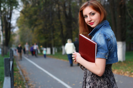 Pretty cute girl walks in the park on a sunny dayの写真素材