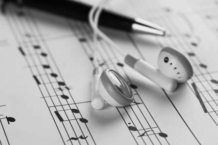 a sheet of white paper with printed thereon music notes on a tableの写真素材