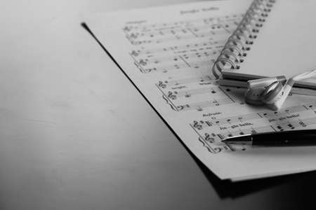 a sheet of white paper with printed thereon music notes on a tableの写真素材