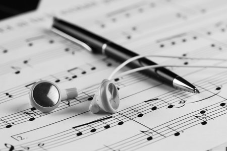 a sheet of white paper with printed thereon music notes on a tableの写真素材