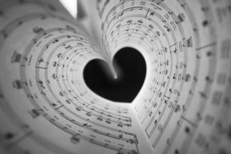 a sheet of white paper with printed thereon music notes on a tableの写真素材