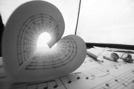 a sheet of white paper with printed thereon music notes on a tableの写真素材