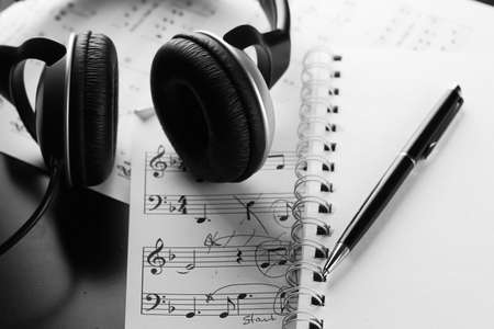 a sheet of white paper with printed thereon music notes on a tableの写真素材