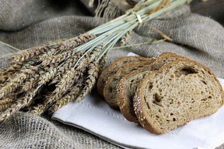 rye bread and ears on the tableの写真素材