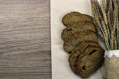 rye bread and ears on the tableの写真素材