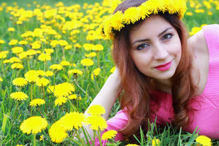 portrait of a cute beautiful girl of European appearance on nature in a summer dayの写真素材