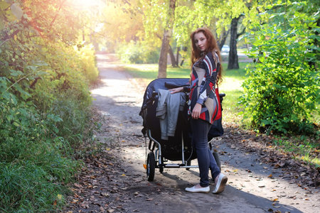 pretty young woman posing on camera in autumn park