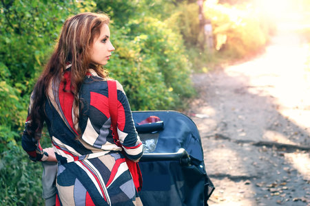pretty young woman posing on camera in autumn park