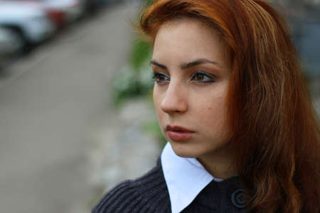 pretty young woman posing on camera in autumn parkの写真素材