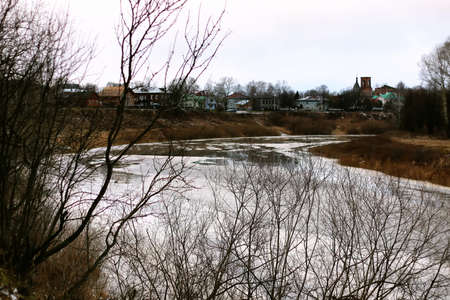 late autumn with the rainy weather in the city park at the church buildingの写真素材