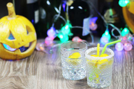 glass of clear liquid with ice cubes and cocktail tubeの写真素材