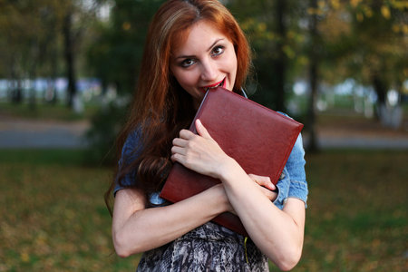 Pretty cute girl walks in the park on a sunny dayの写真素材