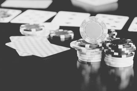colorful chips on a wooden table in a game of Texas Hold'em Pokerの写真素材