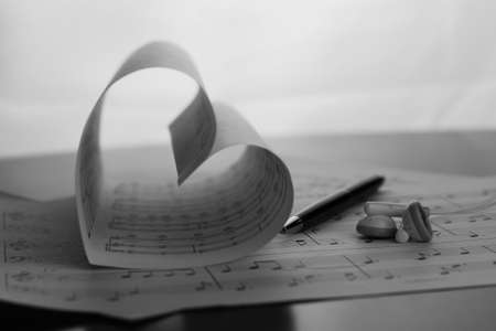 a sheet of white paper with printed thereon music notes on a tableの写真素材
