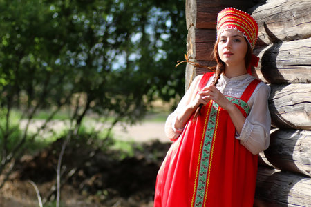 beautiful young girl in traditional red dress Slavic cultureの写真素材