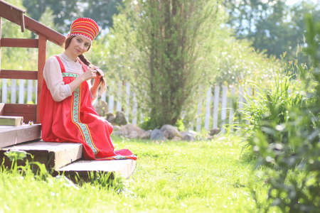 beautiful young girl in traditional red dress Slavic cultureの写真素材