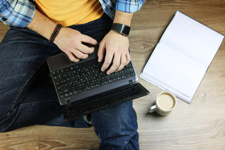 man on the floor with a laptop education and business conceptの写真素材