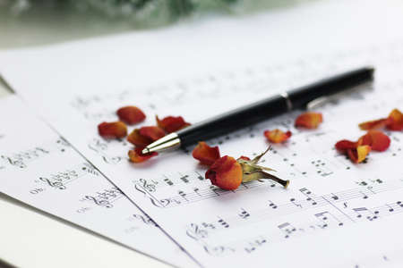 white sheet of paper with musical notes printed with Christmas motifsの写真素材