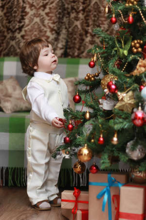 small beautiful children of European appearance decorate the Christmas treeの写真素材