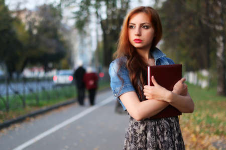 Pretty cute girl walks in the park on a sunny dayの写真素材