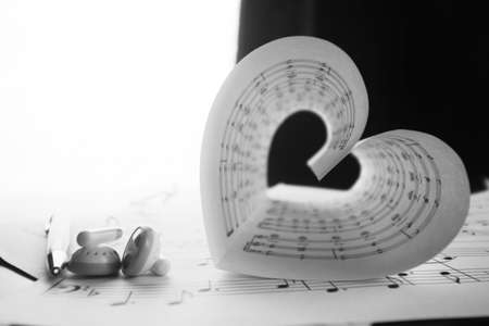 a sheet of white paper with printed thereon music notes on a tableの写真素材