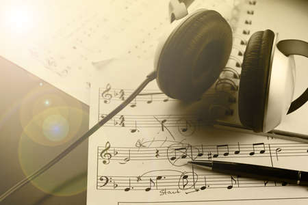 a sheet of white paper with printed thereon music notes on a tableの写真素材