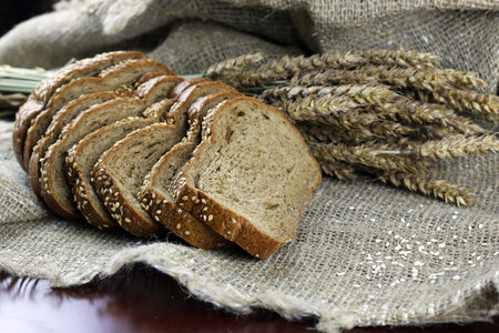 a bouquet of dried rye ears of which makes the bread on the background