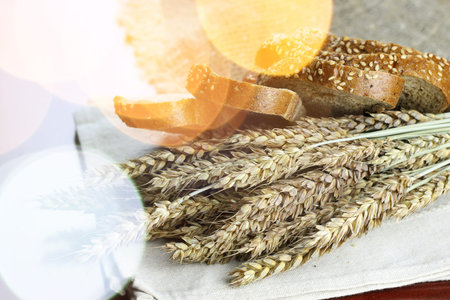 a bouquet of dried rye ears of which makes the bread on the background