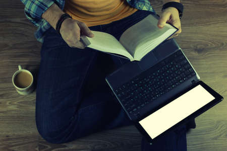 man on the floor with a laptop education and business conceptの写真素材