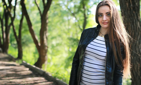 handsome and attractive person in summer strolls through the city streetsの写真素材