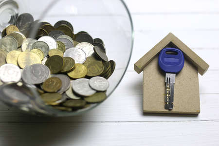 painted on a white wooden table and a scattering of coins Russian different keysの写真素材