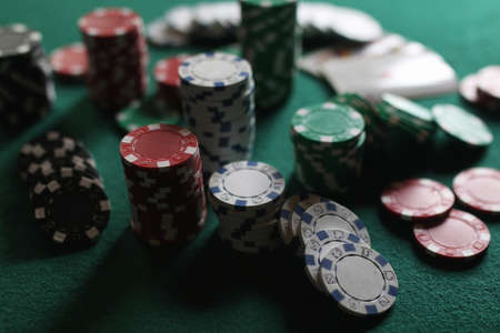 set of chips and cards on a green baize gambling casinoの写真素材