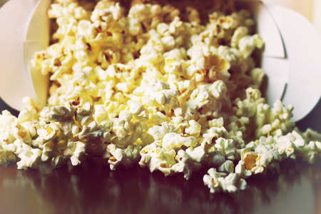 a scattering of popcorn on the wooden floor while watching a movieの写真素材