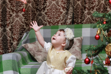 cute little kids on the floor in the interior of a child's room in the new year eveの写真素材