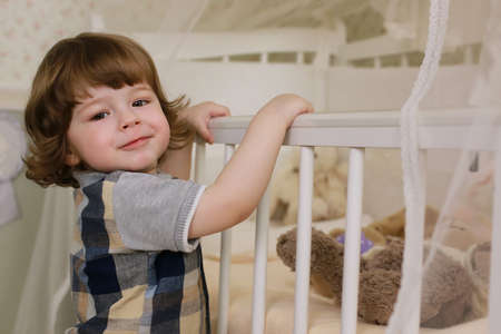 cute little kids on the floor in the interior of a child's roomの写真素材