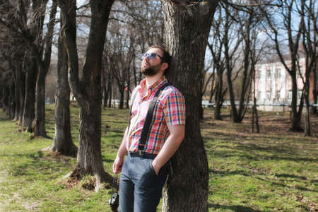 handsome and attractive person in the summer in the landscape of city streets and parksの写真素材