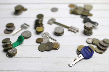 painted on a white wooden table and a scattering of coins Russian different keysの写真素材