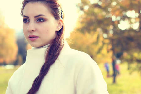 handsome and attractive person in the autumn in the landscape of city streets and parksの写真素材