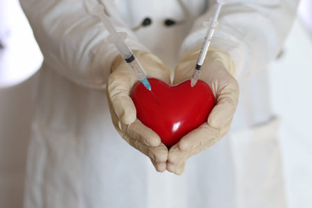 hands in white gloves man dressed in a white robe doctor holding object
