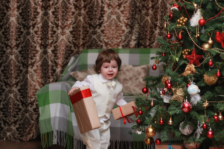 cute little kids on the floor in the interior of a child's room in the new year eveの写真素材