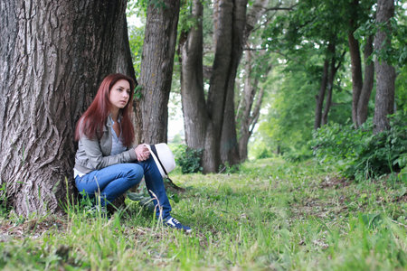 handsome and attractive person in summer strolls through the city streetsの写真素材
