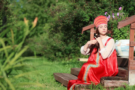 cute pretty girl in a traditional Slavic dress on nature in an unspoilt locationの写真素材