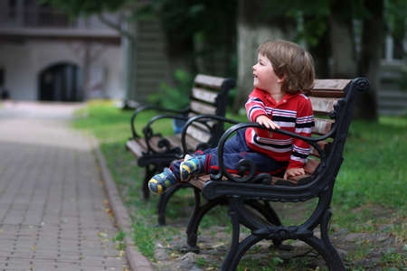 little cute boy having fun and running in the park on a summer sunny dayの写真素材