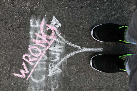 arrows chalk on asphalt concept of choose way of lifeの写真素材