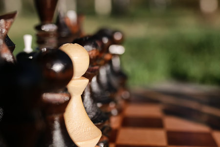 chess pieces arranged on the board mid-game in the fresh airの写真素材