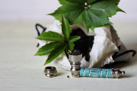 a bag of chopped dry mixture and pipe for marijuana use untreated