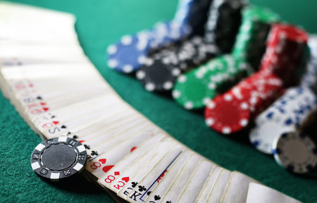 set of chips and cards on a green baize gambling casino
