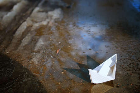 tinted photo paper boat on spring streetの写真素材